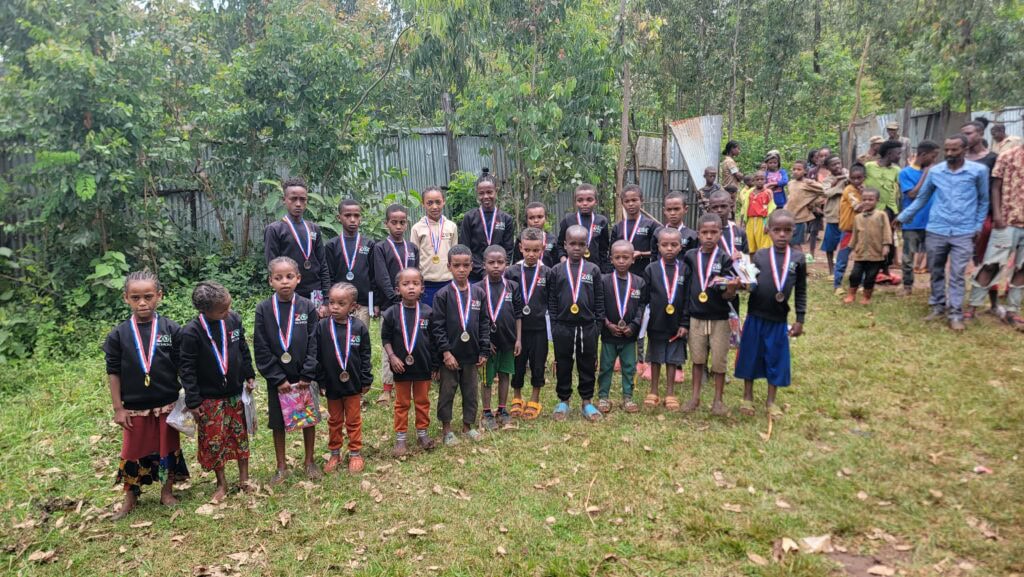 Children with medals at The Zoe Project, Ethiopia, celebrating educational achievements.