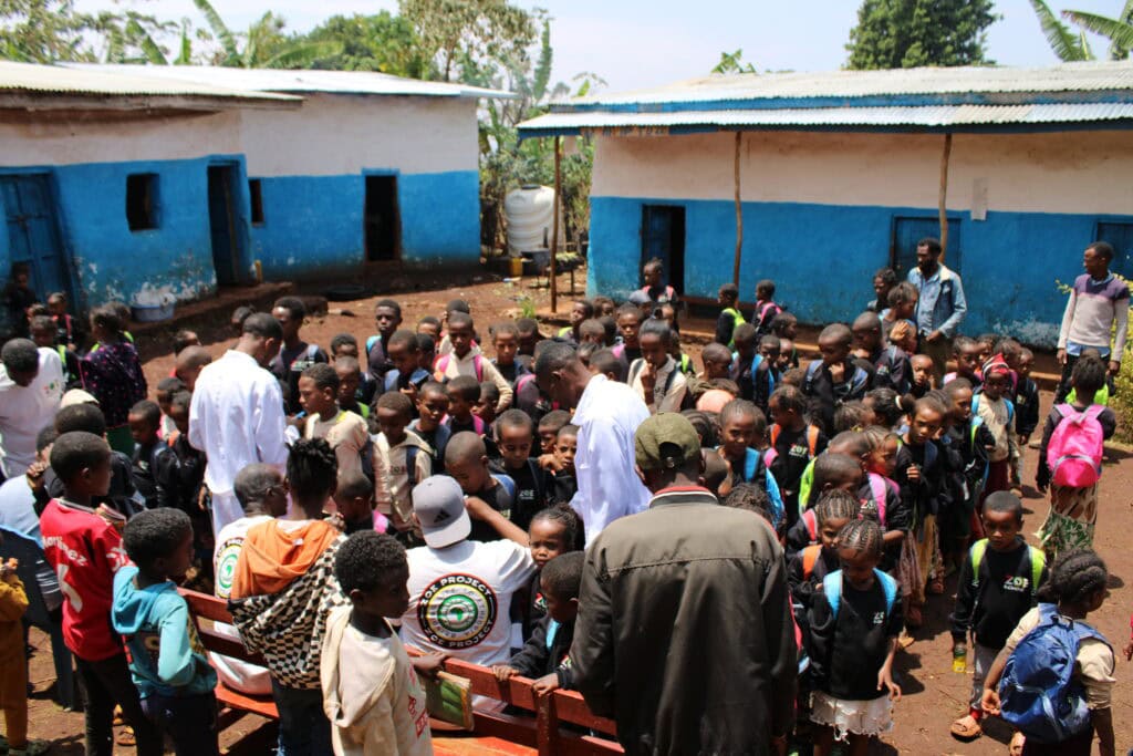 Children gathering at The Zoe Project school in Ethiopia for educational activities and community development.