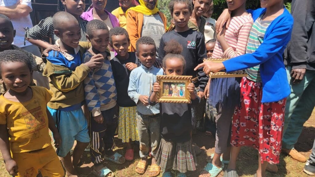 Supportive children and community celebrating educational achievements in Ethiopia with The Zoe Project.